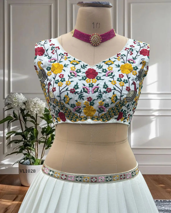 Designer white embroidered lehenga choli set with dupatta displayed on mannequin
